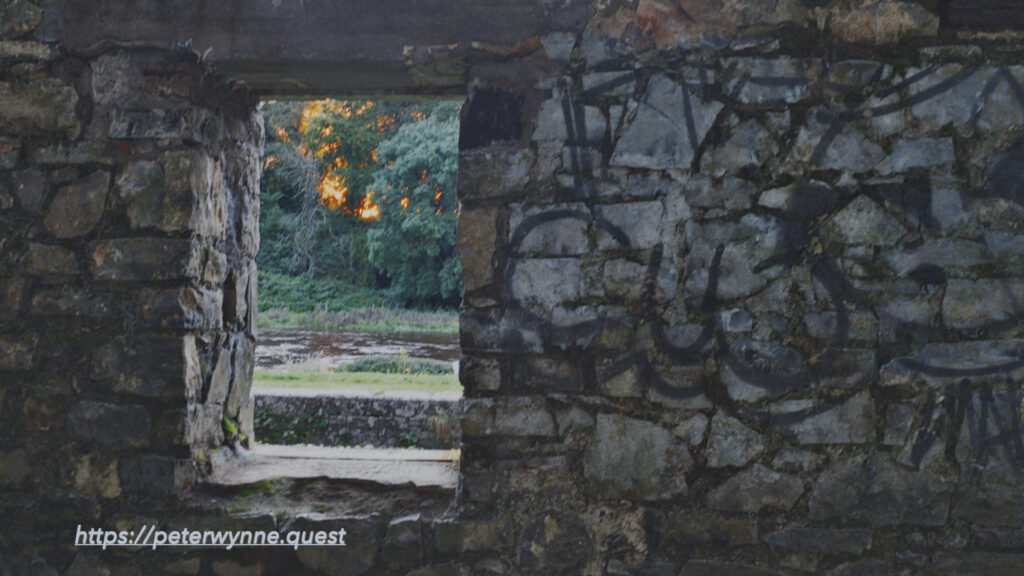 Photo by Peter Wynne of a stone wall with window of an abandoned cottage on the banks of the Boyne river, Navan, Co. Meath, Ireland at sunset.