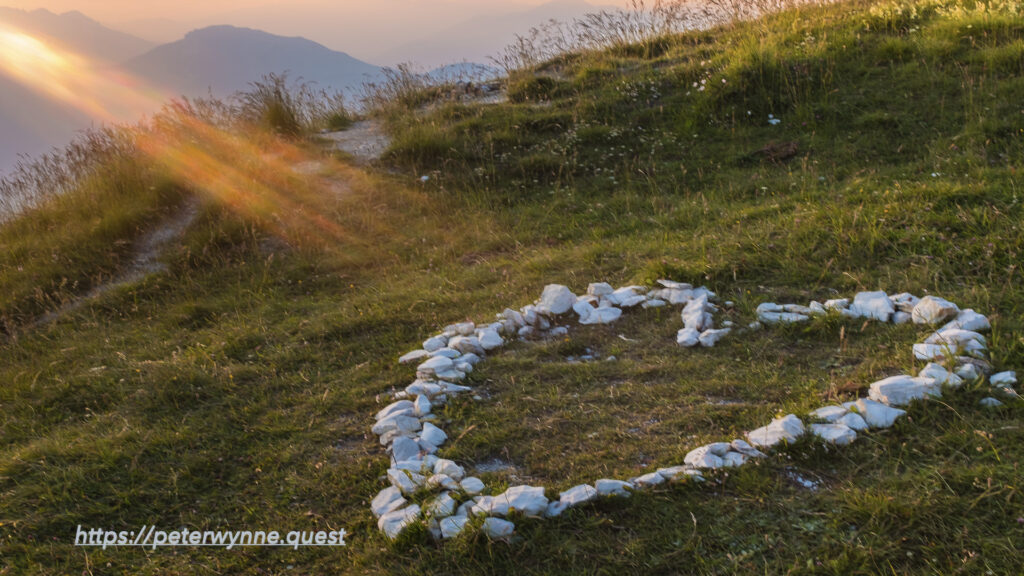 Photo by Peter Wynne of sun rays beaming into a heart shape of stone on Monte Baldo, Lago di Garda.