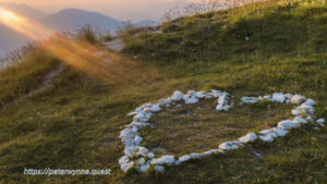 Photo by Peter Wynne of sun rays beaming into a heart shape of stone on Monte Baldo, Lago di Garda.
